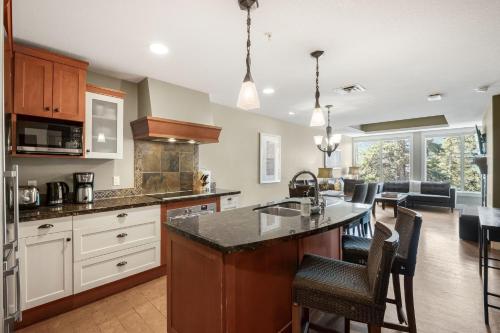 a kitchen with a large island in a room at Star Suite -Luxurious condo with 3 fireplaces, and open Pool! in Canmore