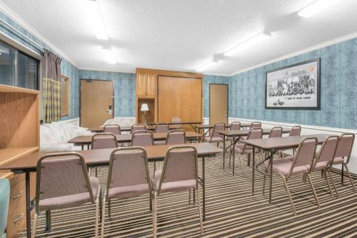 a conference room with tables and chairs in it at Wrangler Hotel Morris in Morris