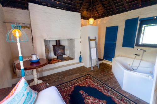 a large bathroom with a tub and a fireplace at The Globe Inn in Yass