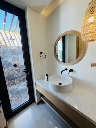 a bathroom with a sink and a mirror at Minh Anh Hotel in Phú Quốc