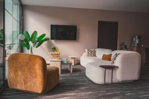 a living room with two chairs and a couch at Lemon Suites & Restaurant in Korucuk