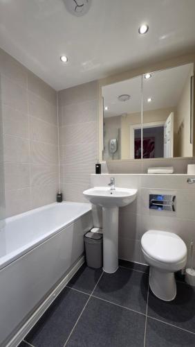 a bathroom with a sink and a tub and a toilet at Wishart Drive in Curborough