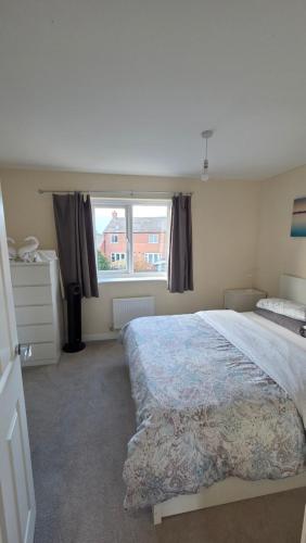 a bedroom with a large bed and a window at Wishart Drive in Curborough