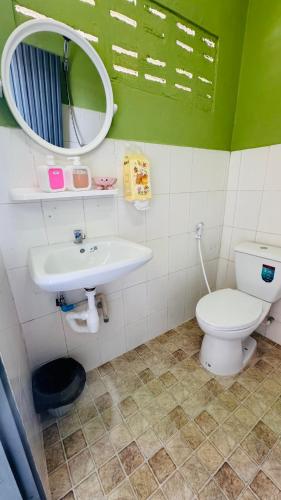 a bathroom with a toilet and a sink and a mirror at BS myhome in Sathani Hat Yai