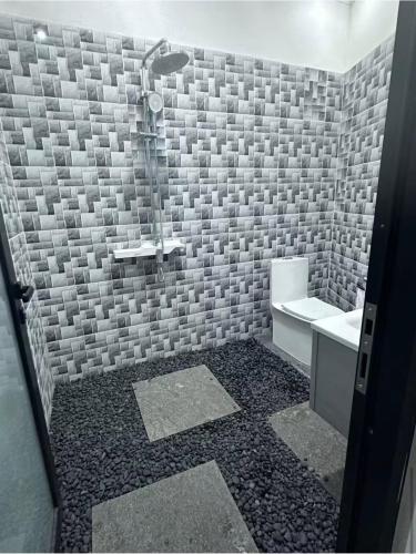 a bathroom with a shower and a sink at Villa Manis in Denpasar