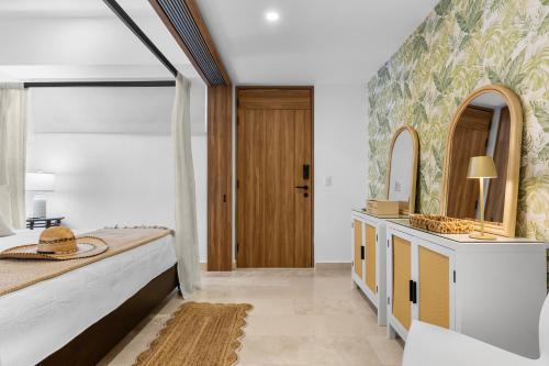 a bedroom with a large bed and a large mirror at Casa Corazon at Harbor 171 North Tower in Puerto Vallarta