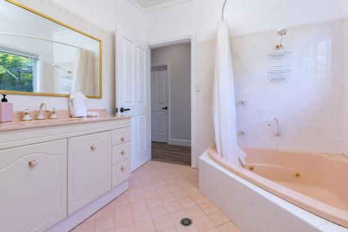a bathroom with a tub and a sink at Billie's on Smiths in Smiths Lake
