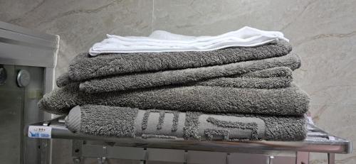 a stack of towels sitting on a rack at Elim Hotel in Neiafu