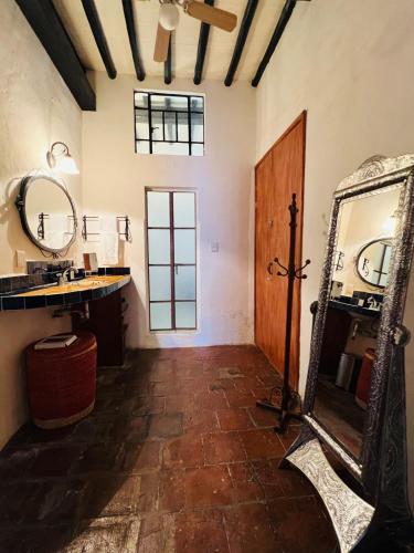 a bathroom with a mirror and a sink at Casa Adobe Balcony Breathtaking Cathedral Views in Taxco de Alarcón