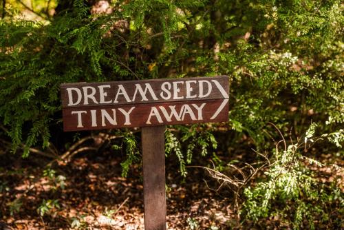 a sign that says dreamsed tiny away on a pole at Dreamseed Cabin by Tiny Away in Yandina