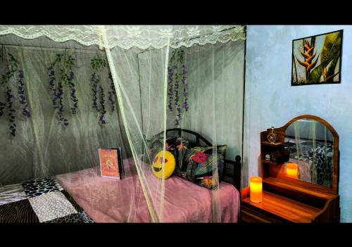 a bedroom with a bed with a canopy and a mirror at Del Mar Tour Camp - Kenya in Busia
