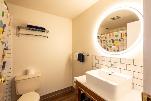 a white bathroom with a sink and a mirror at Chase Country Inn in Chase