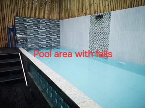 a swimming pool with a pool area with tiles at McHanns Place in Antipolo