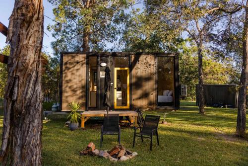 a tiny house in the middle of a yard at Wilderness Whisper 1770 By Tiny Away in Agnes Water