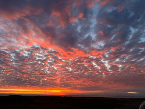 a sunset with colorful clouds in the sky at Historic Block Island Suite in New Shoreham