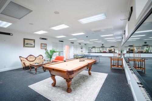 a large room with a pool table in it at Snow Circle Retreat in Bourne
