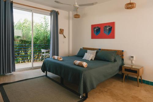 a bedroom with a bed with two pillows on it at Maralagua in Puerto Escondido