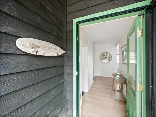 a surfboard on the wall of a house at Baudin Beach House in Gnarabup