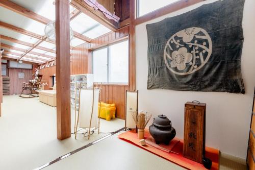 a room with a large painting on the wall at Guest House Kominka Nagomi in Izumi-Sano