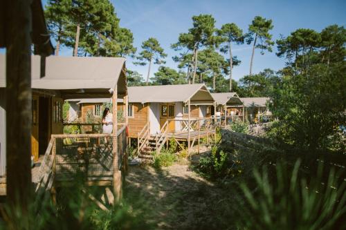 a row of cottages with trees in the background at Naturéo in Seignosse