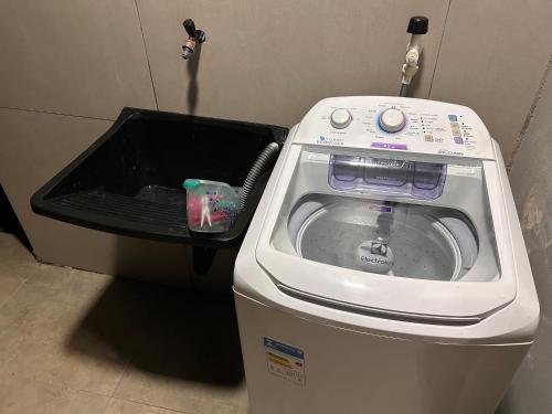 a washing machine with its door open in a room at Casa Mobiliada Conforto e Praticidade in Santa Rosa