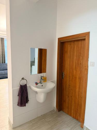 a bathroom with a sink and a mirror at Easternville 4 bedroom Maisonette in Nairobi
