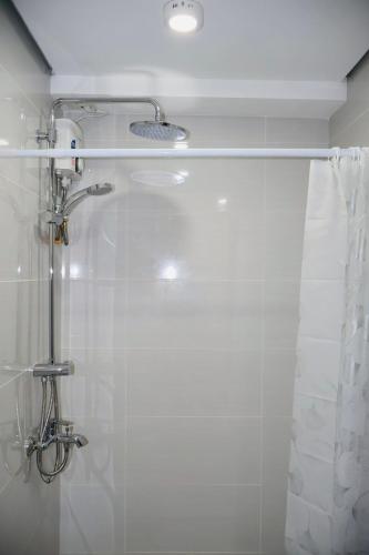 a bathroom with a shower with a shower curtain at Studio Getaway in Cebu City Baseline in Cebu City