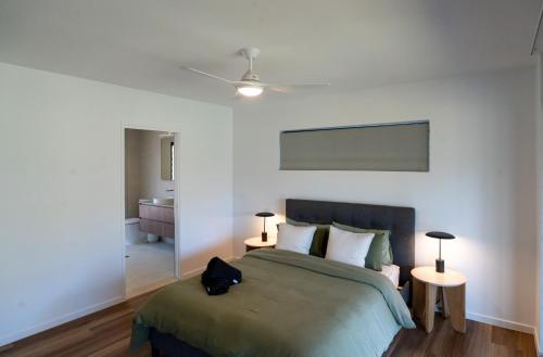 a bedroom with a bed and two tables with lamps at Selah Valley Estate in Limpinwood