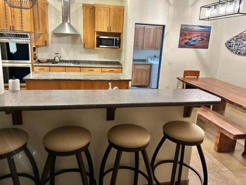 a kitchen with a large counter with stools at Spacious Home in Page