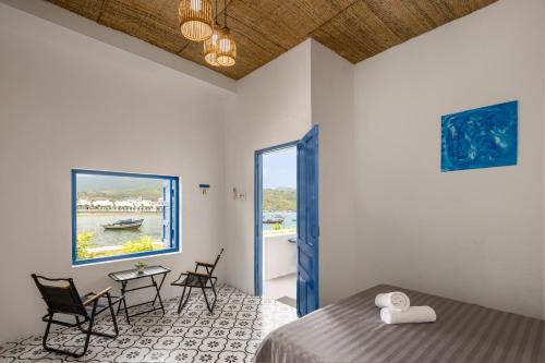 a bedroom with a bed and a table and chairs at O'Stay Vinh Hy in Vĩnh Hy