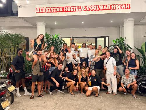 a group of people posing for a picture in front of a building at Bed Station Hostel & Pool Bar Hội An " Former Sunflower" in Hoi An