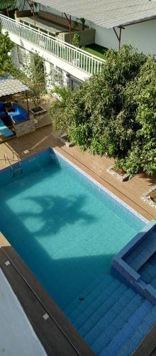an overhead view of a large blue swimming pool at Villa Nostra in Ngaparou
