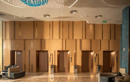 a lobby with a row of elevators in a building at Anyla Sầm Sơn Hotels in Sầm Sơn