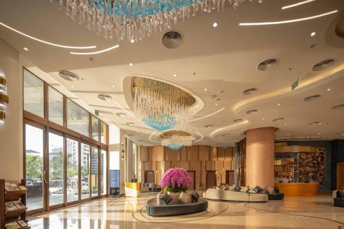 a lobby of a hotel with a chandelier at Anyla Sầm Sơn Hotels in Sầm Sơn
