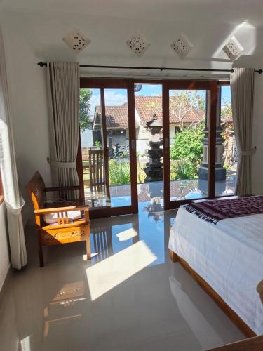 a bedroom with a bed and a sliding glass door at Okasarna Guesthouse in Sidemen