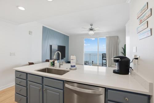a kitchen with a sink and a view of the ocean at Splash Resort, 16th floor, Oceanfront, 1BR Sleeps 6, Lazy River & Water Park in Panama City Beach