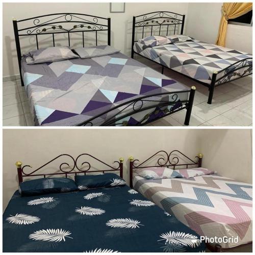 two beds sitting next to each other in a bedroom at Homestay kampung dusun in Balik Pulau