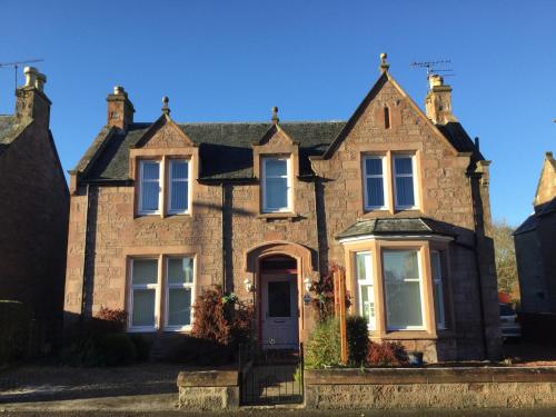 a large brick house with a front door at St Ann’s Guest House in Inverness