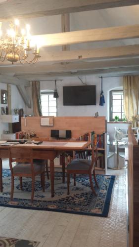 a living room with a large wooden table and chairs at Holzwerk Oybin in Kurort Oybin