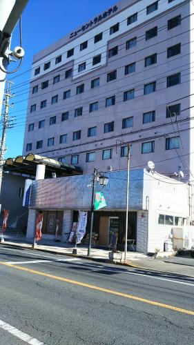 a large building on the side of a street at New Central Hotel Katsuta in Hitachinaka