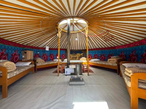 a room with a large tent with beds in it at Gaya's Guest House in Harhorin