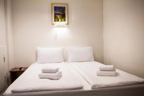 a bedroom with a bed with towels on it at Hotel Expo Stockholm in Stockholm