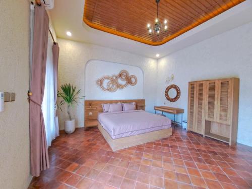 a bedroom with a bed in a room at Princessa Villa by Raminten in Pakem