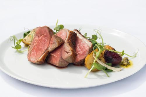 a plate of food with meat and a salad at The Falcon Hotel in Uppingham