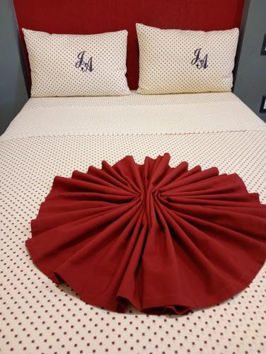 a bed with a red dress on top of it at J Alejandro - Centro Histórico Guadalajara in Guadalajara
