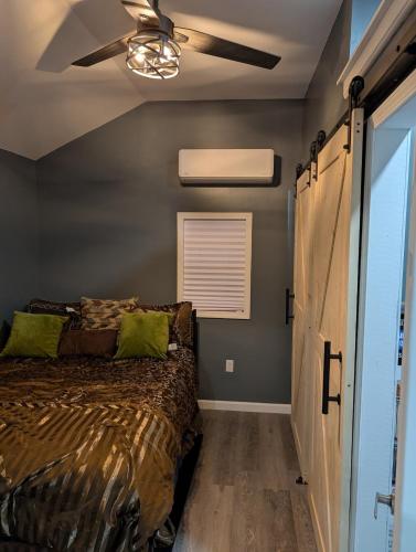 a bedroom with a bed and a ceiling fan at Genesis Get Away in Evergreen