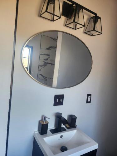a bathroom with a sink and a mirror at Genesis Get Away in Evergreen