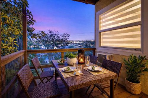 a table and chairs on a balcony with a view at CasaViva Garden - 2BR with Firepit, S'mores & Kids Playset - Walk to Eats, Near Zoo, SeaWorld & Balboa Park in San Diego