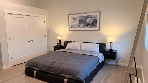 a bedroom with a bed with two night stands and two lamps at The Sandpearl in Stevensville
