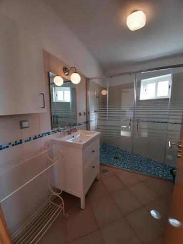 a bathroom with a sink and a shower at Quinta do Maranhão in Lagos